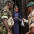 Malagasy army soldiers distribute masks and samples of a local herbal tea, touted by President Andry Rajoelina as a powerful remedy against the COVID-19 coronavirus, in Antananarivo