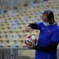A ball boy disinfects the ball during a Carioca Championship 2020 football match between Flamengo and Bangu at the Maracana stadium, in Rio de Janeiro, Brazil, on June 18, 2020