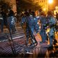 Police charge a barricade in the street during a demonstration against the death of George Floyd near the White House