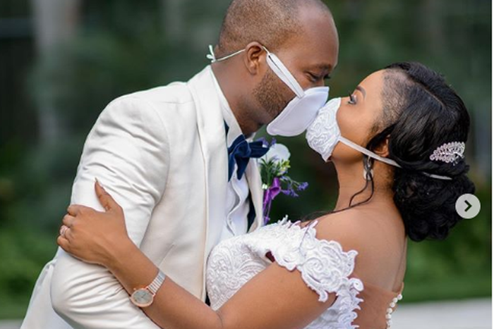 A touching photo shows how two newlyweds shared their first kiss through face masks.