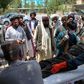 A  man injured in an explosion at a cattle market is brought to in Lashkar Gah, Helmand province