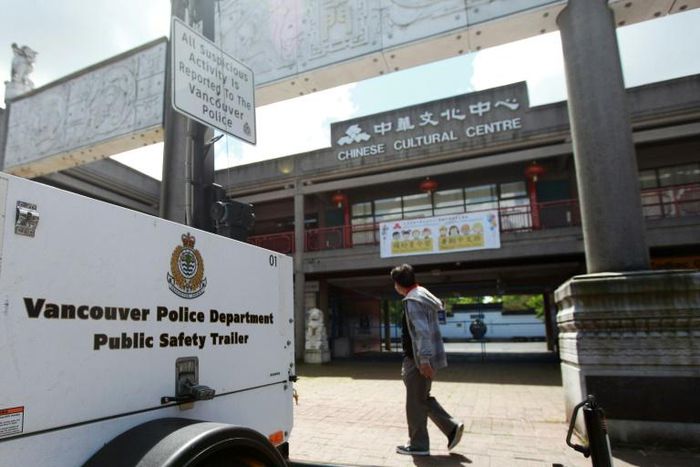 A man walks past Vancouver's Chinese Cultural Centre, which was targeted with vandalism during the COVID-19 pandemic, prompting police to erect mobile surveillance cameras