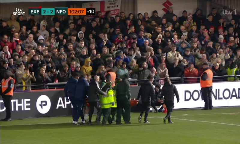 Exeter vs Forest: Ambulance crew rushes to aid Awoniyi after bloody on-pitch collision. Photo credit: ITV