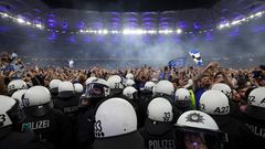 Wild stadium invasion and police clash leaves 25 fans seriously injured