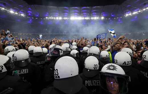 Wild stadium invasion and police clash leaves 25 fans seriously injured