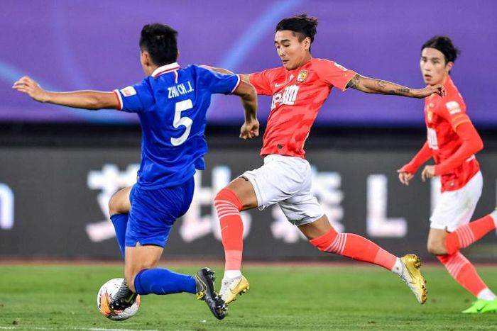 Guangzhou Evergrande's Wei Shihao (C) scored four goals in the first three games of the season