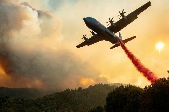 An aircraft drops fire retardant on a ridge during the Walbridge fire, part of the larger LNU Lightning Complex fire, as flames continue to spread in Healdsburg, California on August 20, 2020