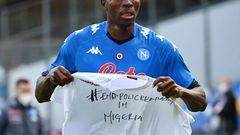 Napoli forward Victor Osimhen holds up a t-shirt 'End police brutality in Nigeria'.