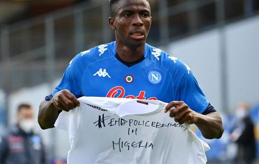 Napoli forward Victor Osimhen holds up a t-shirt 'End police brutality in Nigeria'.
