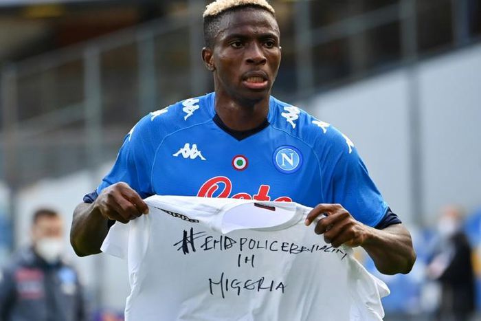 Napoli forward Victor Osimhen holds up a t-shirt 'End police brutality in Nigeria'.
