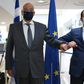 Cypriot Foreign Minister Nicos Christodoulides (R) greets with an elbow bump his Greek counterpart Nikos Dendias in Nicosia