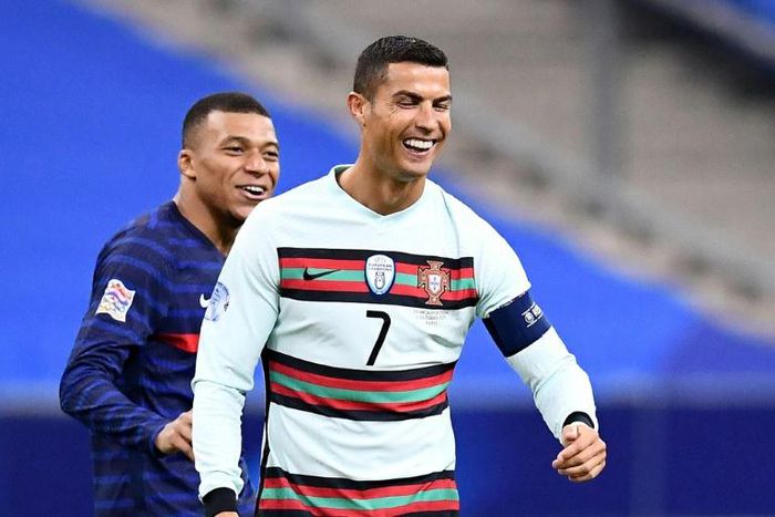 Cristiano Ronaldo and Kylian Mbappe share a joke during the goalless draw between France and Portugal last month. The sides meet again in a potentially decisive encounter in Lisbon this weekend