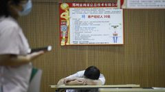 A jobseeker takes a break at a recruitment fair in Zhengzhou, China. Young graduates face a tough employment market