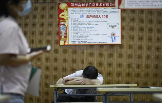 A jobseeker takes a break at a recruitment fair in Zhengzhou, China. Young graduates face a tough employment market