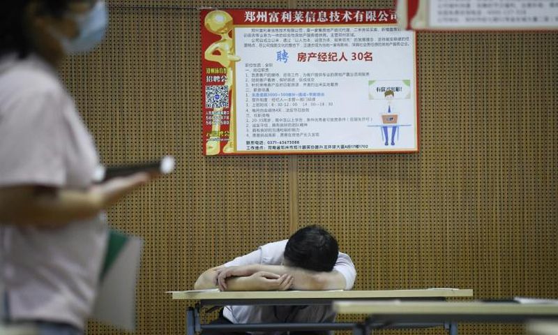 A jobseeker takes a break at a recruitment fair in Zhengzhou, China. Young graduates face a tough employment market