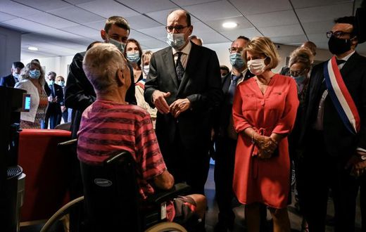 French Prime Minister Jean Castex, centre, warned of heat risks while visiting a retirement home