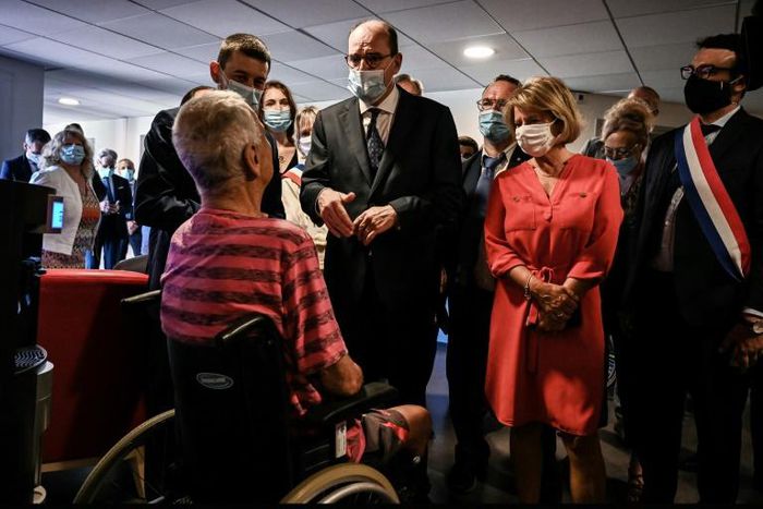French Prime Minister Jean Castex, centre, warned of heat risks while visiting a retirement home