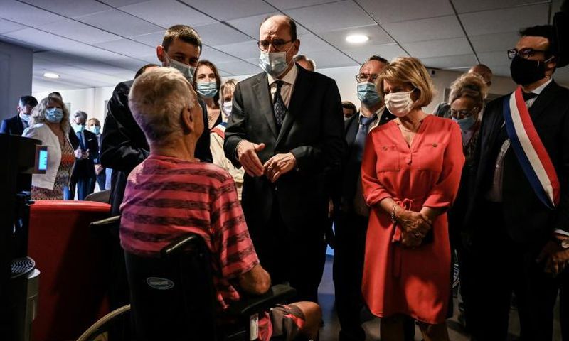 French Prime Minister Jean Castex, centre, warned of heat risks while visiting a retirement home