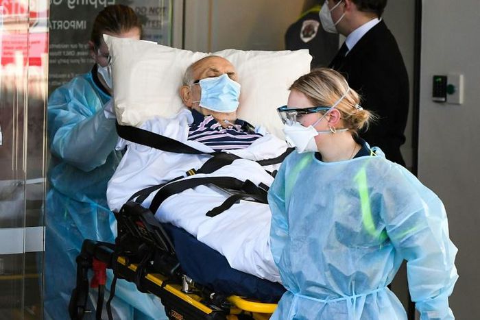 Ambulance officers transport a resident from the Epping Gardens care facility