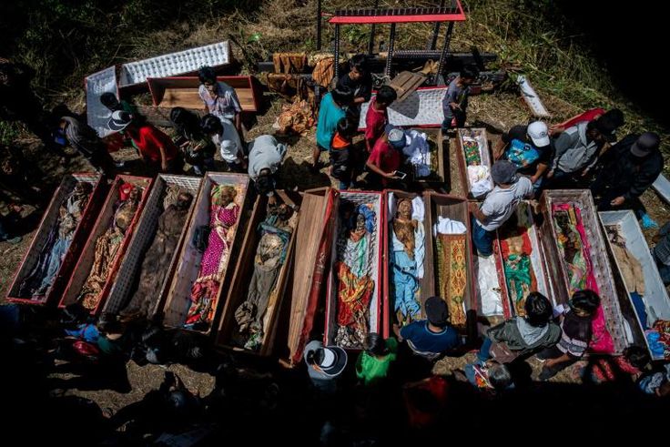 Torajan families unearth deceased relatives and clean their graves in a ritual known as "Manene"
