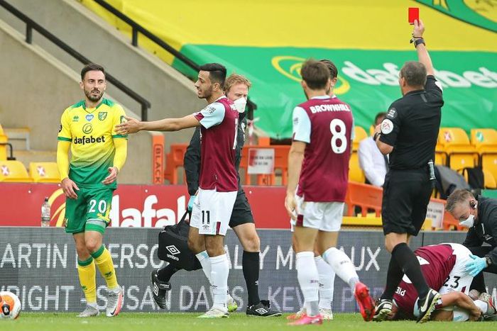 Referee Kevin Friend shows a red card to Norwich's Josip Drmic