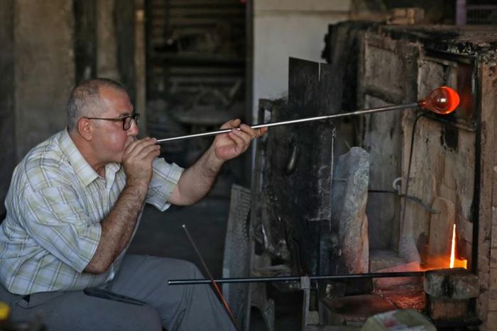 Mohamed al-Hallak and his brothers are the last family to keep up the tradition of glass-blowing in Syria's capital Damascus, according to a craft association