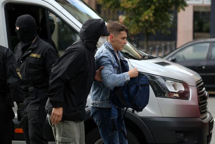 A law enforcement officer detains a student in Minsk on Tuesday