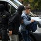 A law enforcement officer detains a student in Minsk on Tuesday
