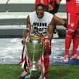 Bayern Munich centre-back David Alaba celebrates with the Champions League trophy.