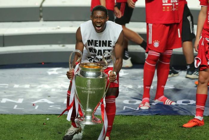 Bayern Munich centre-back David Alaba celebrates with the Champions League trophy.
