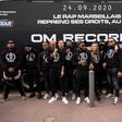 Rap artists from Marseille pose in front of a bus during the launch new rap record label OM Records