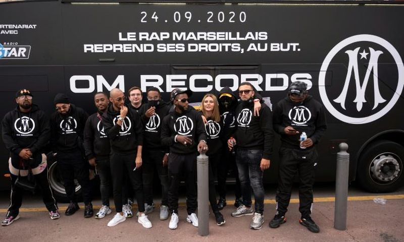 Rap artists from Marseille pose in front of a bus during the launch new rap record label OM Records