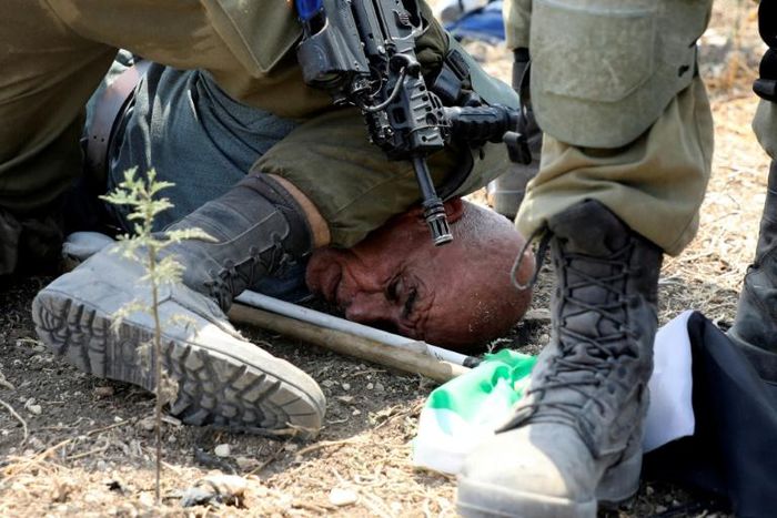 Israeli soldiers detain a Palestinian protester on September 1, 2020