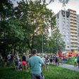 People look on as firefighters work at the scene where a fire broke out in an apartment block in Bohumin, eastern Czech Republic on August 8, 2020, killing eleven people including three children