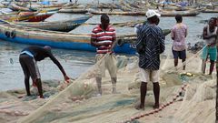 Fishermen mending their nets