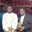 Kuami Eugene presents 2020 VGMA plaques to his pastor