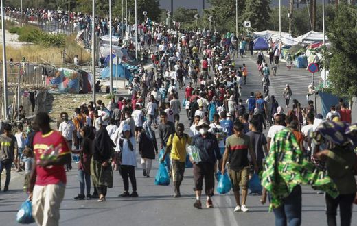 Hundreds of migrants have reluctantly made their way to the new site in the searing heat