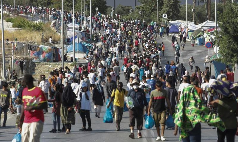 Hundreds of migrants have reluctantly made their way to the new site in the searing heat