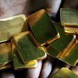 FILE PHOTO: A worker shows gold biscuits at a precious metals refinery in Mumbai