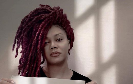 Nadia Buari holds "End SARS" placard