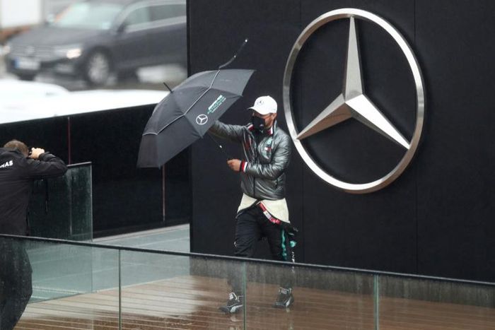 Valtteri Bottas posed with an umbrella as rain prevent practice at the Nurburgring