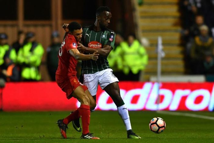Plymouth Argyle striker Jordan Slew is tackled by Trent Alexander-Arnold in an FA cup match in 2017 - Plymouth have raised the money to commemorate Jack Leslie, a black player from the 1920s