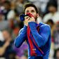 Barcelona forward Lionel Messi kisses his jersey after brandishing it to celebrate his goal against Real Madrid