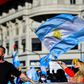 People wave Argentine flags during a protest in Buenos Aires against the government's tight lockdown measures against the spread of the novel COVID-19 coronavirus