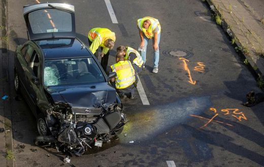 The mangled black Opel Astra on Berlin's Autobahn 100 after its driver caused three accidents