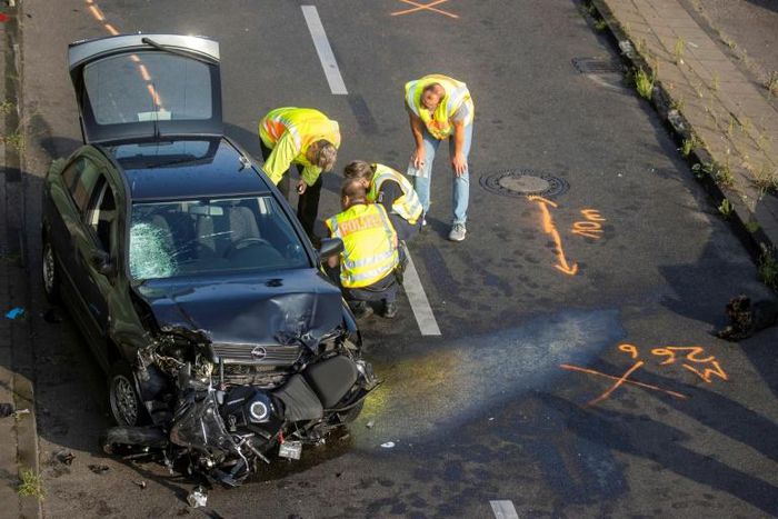 The mangled black Opel Astra on Berlin's Autobahn 100 after its driver caused three accidents