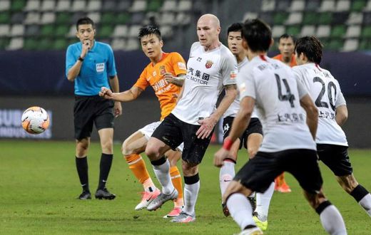 Aaron Mooy (centre) said he hadn't been expecting to make his debut for Shanghai SIPG on his 30th birthday, but then scored with a cool finish to celebrate
