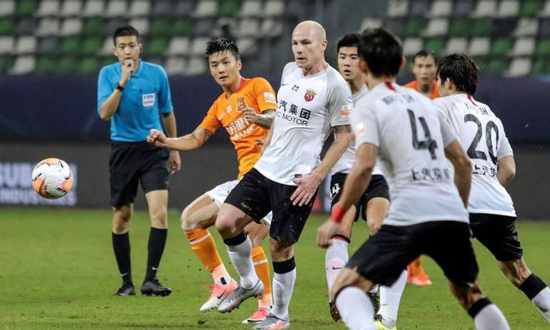 Aaron Mooy (centre) said he hadn't been expecting to make his debut for Shanghai SIPG on his 30th birthday, but then scored with a cool finish to celebrate