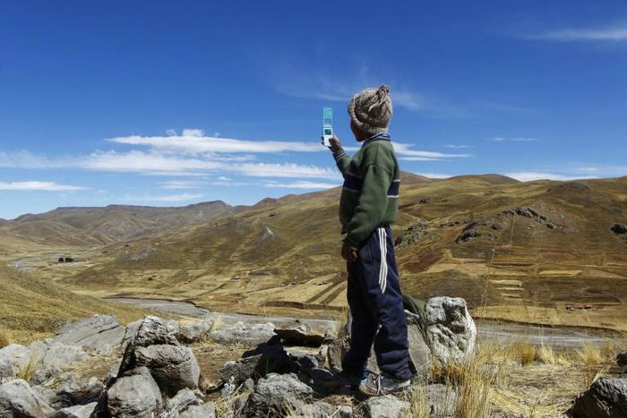 Alvaro Cabrera, 10, searches for a cellphone signal atop a hill near Manazo, Peru while trying to take part in a virtual class; the UN says Covid-19 and school closures have left millions of children worldwide unable to access distance education