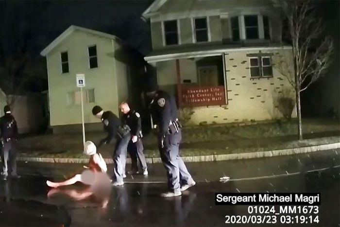 This image taken from police bodycam video released by the Rochester, New York, Police Department, shows police arresting Daniel Prude on March 23, 2020 after putting a hood on his head